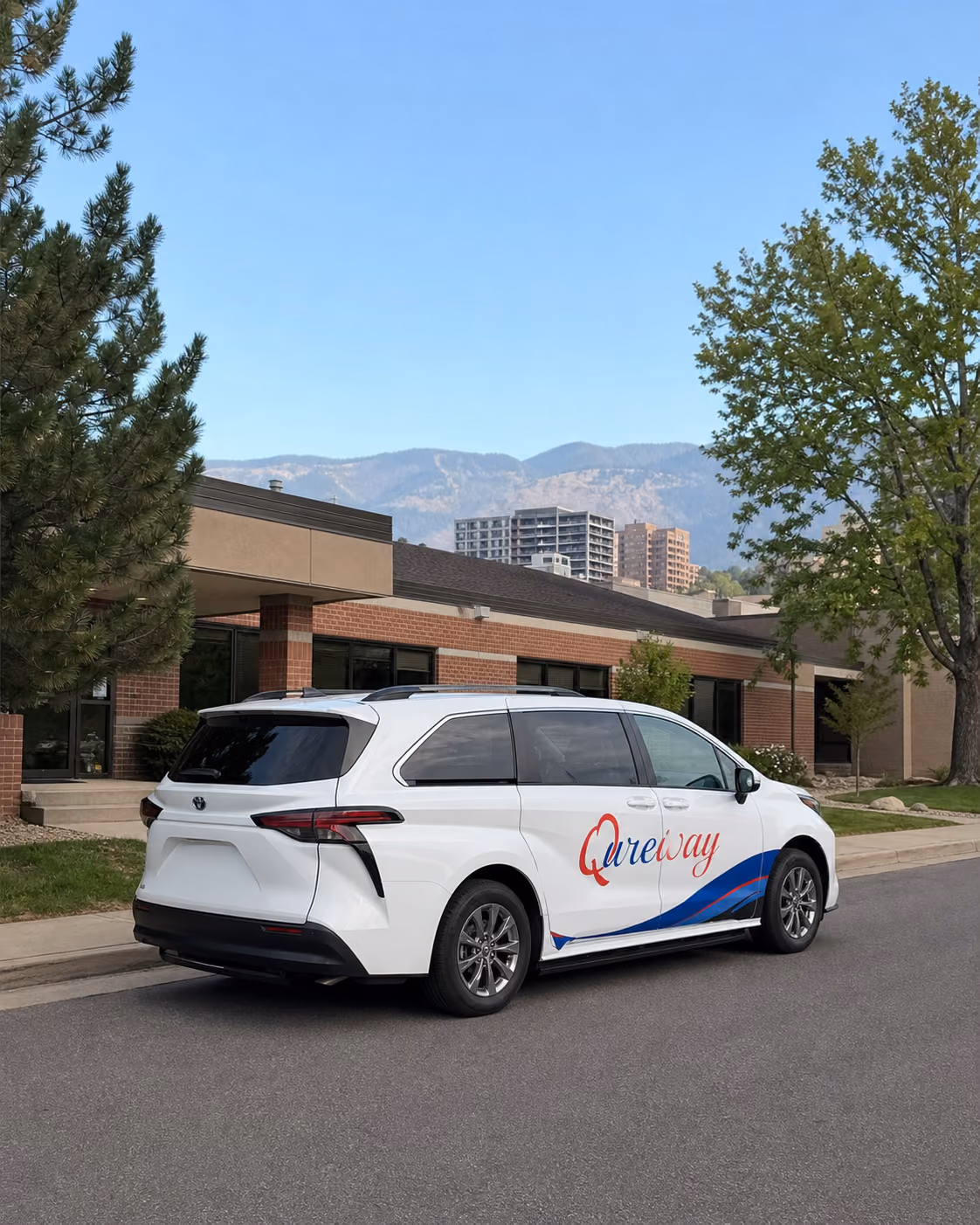 A Qureway wheelchair-accessible van traveling through the Denver metro area