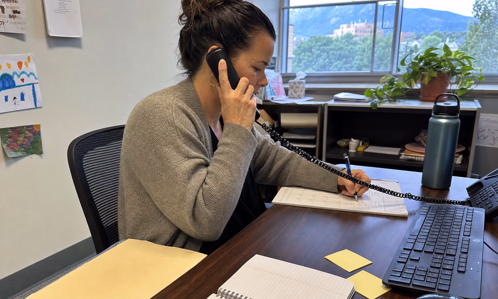 A case manager coordinating transportation from a working office